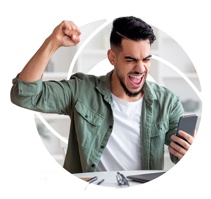 a man looking at his phone and cheering