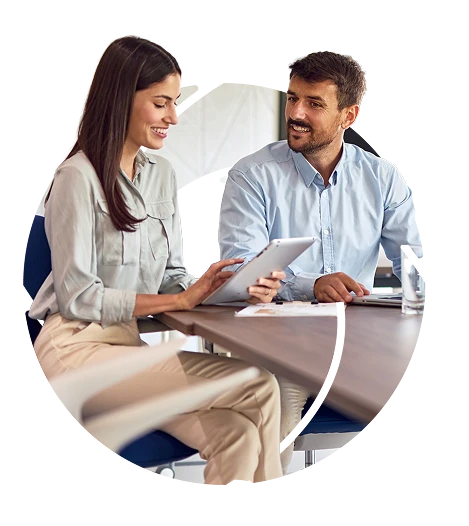 a couple at a cafe reviewing finances on a tablet