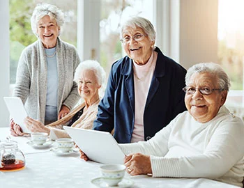 a group of senior ladies enjoying tea