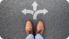 feet standing in front of a sign indicating multiple paths
