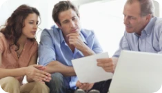 a couple speaking with an investment manager