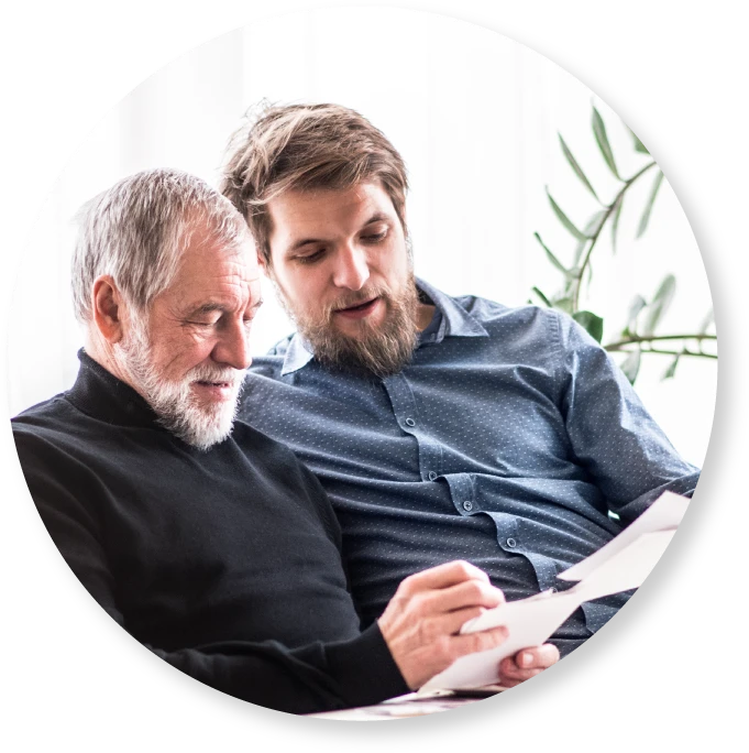 a man with his dad looking at papers