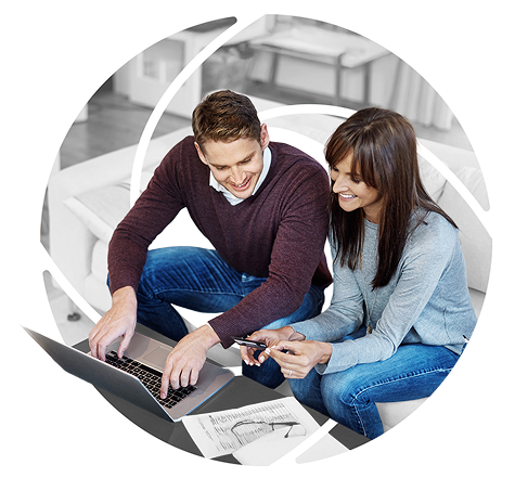 a couple working on their finances on a phone and a laptop