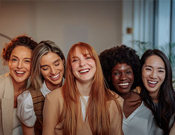 a group of women posing and smiling