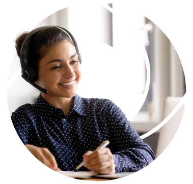 a call center worker smiling while writing things down